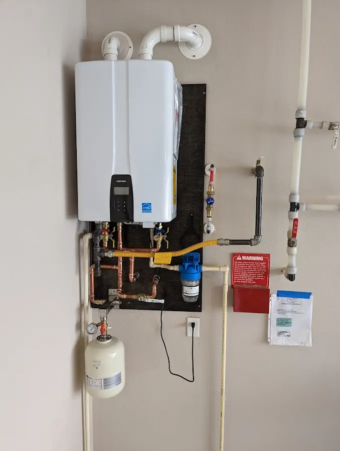 Professional plumber installing copper piping in a Woodbury home